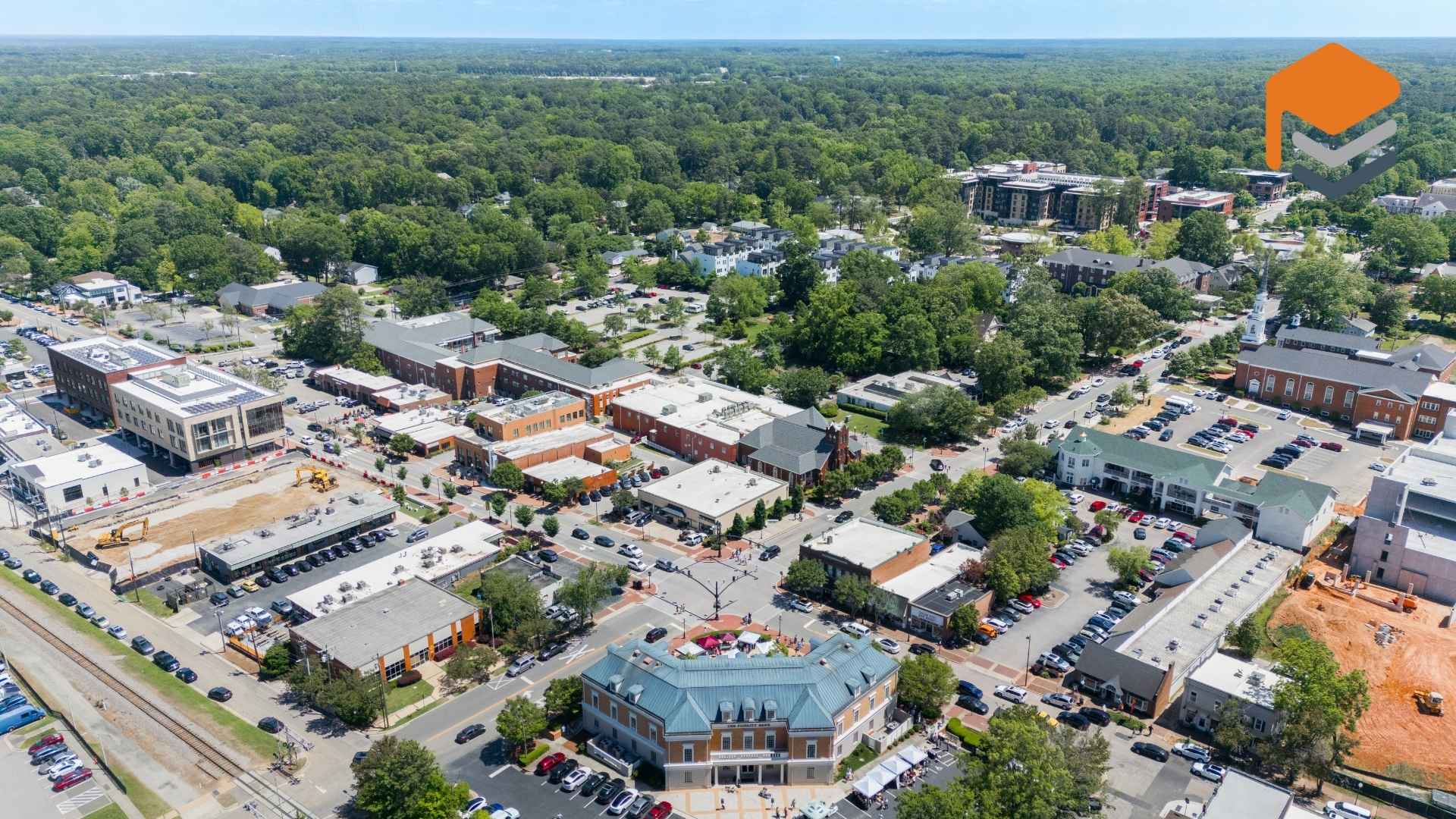 Aerial view of downtown Cary, North Carolina with trees and buildings.