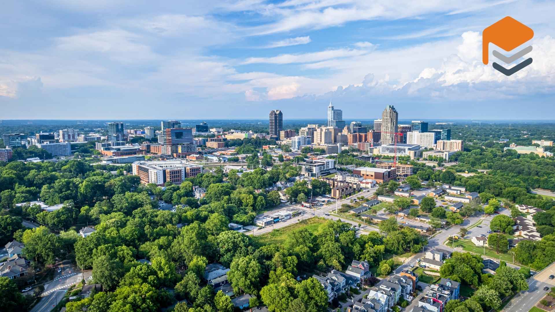 Aerial view of Raleigh, North Carolina skyline and green landscape.
