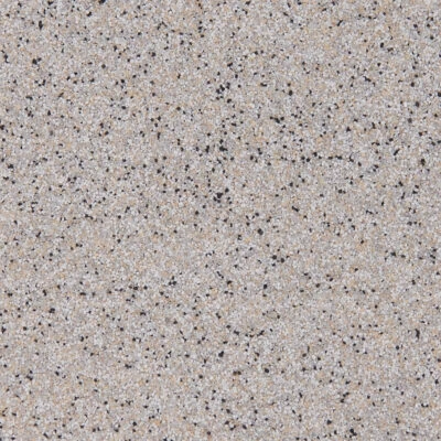 Beige speckled granite texture surface close-up.