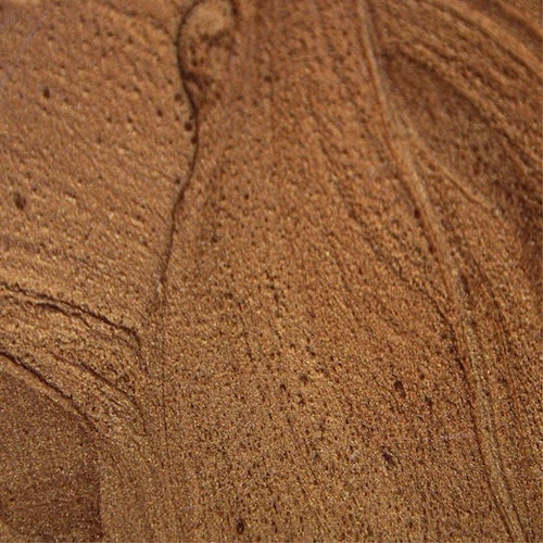 Close-up of swirling brown texture pattern.