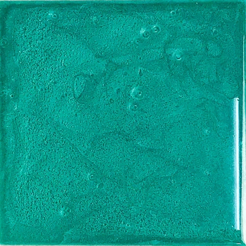 Close-up of a textured turquoise glass tile.