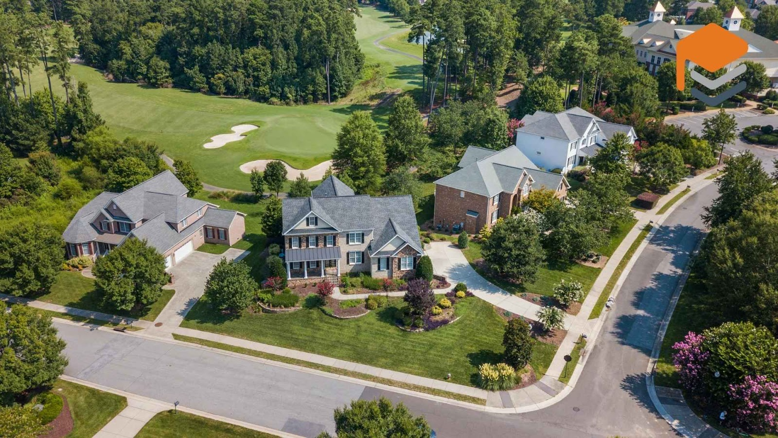 an aerial view of a neighborhood with houses and golf course in raleig, NC