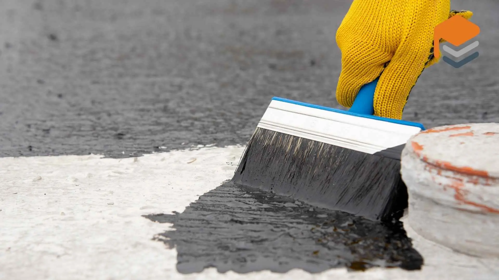 Applying black waterproof sealant with brush on roof.